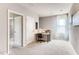 Hallway featuring a desk and chair, a window, and two entryways at 1839 Waggoner St, Kissimmee, FL 34744