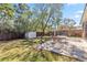 Spacious backyard with green grass, a storage shed, and a patio area at 1870 Bridgeview Cir, Orlando, FL 32824