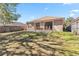 View of the backyard featuring a well-maintained lawn and a cozy outdoor patio at 1870 Bridgeview Cir, Orlando, FL 32824