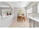 Bright breakfast nook features tile flooring, a wooden table set, and windows overlooking the greenery outside at 1870 Bridgeview Cir, Orlando, FL 32824