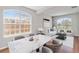 Bright dining room with a marble table, arched windows and stylish furniture at 1870 Bridgeview Cir, Orlando, FL 32824