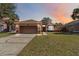 Charming single-story home with a well-manicured lawn and a two-car garage at 1870 Bridgeview Cir, Orlando, FL 32824