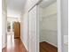 Hallway with wood floors leading to walk-in closet and main bedroom with backyard access at 1870 Bridgeview Cir, Orlando, FL 32824