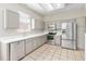 The kitchen features stainless steel appliances, bright counters, and tile floors at 1870 Bridgeview Cir, Orlando, FL 32824