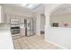 Updated kitchen featuring stainless steel appliances, shaker cabinets, and tiled floor at 1870 Bridgeview Cir, Orlando, FL 32824