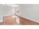 Bright living room featuring hardwood floors, a large arched window, and neutral wall color at 1870 Bridgeview Cir, Orlando, FL 32824