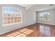 Spacious living room with hardwood floors, natural light, and two large arched windows at 1870 Bridgeview Cir, Orlando, FL 32824