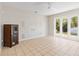 Bright living room with tile floors, a decorative cabinet, and sliding doors to the backyard at 1870 Bridgeview Cir, Orlando, FL 32824