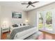 Comfortable bedroom with a ceiling fan and sliding glass doors to the backyard at 1870 Bridgeview Cir, Orlando, FL 32824