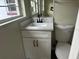 Bathroom features a modern vanity with sleek fixtures and a toilet at 1926 Kingsland Ave, Orlando, FL 32808