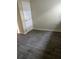 Bright bedroom featuring gray wood-look tile flooring and neutral wall paint at 1926 Kingsland Ave, Orlando, FL 32808