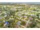 Overhead view of a quaint community featuring mature trees and a variety of single-Gathering homes at 2130 Pope Ave, South Daytona, FL 32119