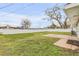 Fenced backyard features green grass, and a concrete patio at 2130 Pope Ave, South Daytona, FL 32119