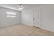 Bright bedroom with tan tile flooring, ceiling fan, and natural light from a window at 2130 Pope Ave, South Daytona, FL 32119