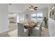 Dining room boasts an elegant table set, a modern ceiling fan, and bright natural lighting at 2130 Pope Ave, South Daytona, FL 32119