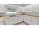 Clean kitchen featuring white cabinets, tile flooring and a stainless steel sink at 2130 Pope Ave, South Daytona, FL 32119