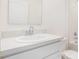 Well-lit bathroom vanity with white cabinets and marble countertop at 229 Magellan Ave, Kissimmee, FL 34758