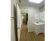 Bathroom featuring wood-look flooring, a vanity, and an open doorway at 2394 Orange Center Blvd, Orlando, FL 32805