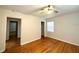 Bright bedroom with hardwood floors, a ceiling fan, and access to a closet at 2394 Orange Center Blvd, Orlando, FL 32805