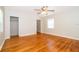 Bright bedroom with hardwood floors, ceiling fan, and ample natural light at 2394 Orange Center Blvd, Orlando, FL 32805