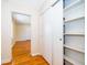 Bright hallway with hardwood floors, white trim, closet and shelves at 2394 Orange Center Blvd, Orlando, FL 32805