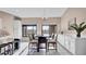 Dining area featuring a dark wood table set, white cabinets, and tile flooring at 2417 Hybrid Dr, Kissimmee, FL 34758