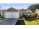 Charming one-story home with a well-manicured lawn and a two-car garage at 2417 Hybrid Dr, Kissimmee, FL 34758