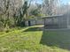 A view of the backyard with a screened in porch and a shed for additional storage at 2602 Talon Ct, Orlando, FL 32837