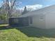 A view of the home's exterior with a screened-in porch and a well-maintained lawn at 2602 Talon Ct, Orlando, FL 32837