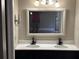 Modern bathroom featuring double sinks, a decorative mirror and updated fixtures at 2602 Talon Ct, Orlando, FL 32837