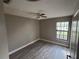 Cozy bedroom featuring wood-look floors, a ceiling fan, and neutral paint at 2602 Talon Ct, Orlando, FL 32837