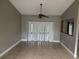 Neutral dining room featuring tile flooring, a ceiling fan, and outdoor access at 2602 Talon Ct, Orlando, FL 32837