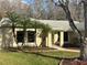 Inviting front entrance with a well-maintained lawn, framed by palm trees and mature landscaping at 2602 Talon Ct, Orlando, FL 32837