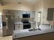 Contemporary kitchen showcasing stainless steel appliances, granite countertops, and grey cabinetry at 2602 Talon Ct, Orlando, FL 32837