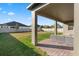 Covered patio with brick flooring and outdoor seating, overlooking a spacious backyard at 2620 Cedar Shake Ct, Oviedo, FL 32765