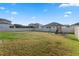 Large grassy backyard with a playset and a fence at 2620 Cedar Shake Ct, Oviedo, FL 32765