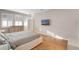 Bright bedroom with hardwood floors, plantation shutters, and a mounted television at 2620 Cedar Shake Ct, Oviedo, FL 32765