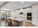 Bright kitchen featuring white cabinets, stainless steel appliances, and an island with seating at 2620 Cedar Shake Ct, Oviedo, FL 32765