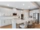 Modern kitchen featuring white cabinetry, stainless steel appliances, and a center island with seating at 2620 Cedar Shake Ct, Oviedo, FL 32765