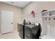 Functional laundry room with modern appliances, ample storage, and a convenient layout at 2620 Cedar Shake Ct, Oviedo, FL 32765