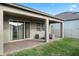 Covered patio features brick flooring, outdoor furniture, and sliding glass door to home's interior at 2620 Cedar Shake Ct, Oviedo, FL 32765