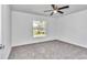 Bedroom with neutral carpet, a ceiling fan, and a window providing natural light at 280 Marion Oaks Golf Way, Ocala, FL 34473