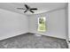 Bedroom with neutral carpet, a ceiling fan, and a window providing natural light at 280 Marion Oaks Golf Way, Ocala, FL 34473