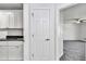 Hallway view showcases the transition from the laundry room to the carpeted bedroom at 280 Marion Oaks Golf Way, Ocala, FL 34473