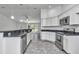 Bright open kitchen featuring granite countertops, stainless steel appliances, and tile flooring at 280 Marion Oaks Golf Way, Ocala, FL 34473