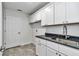 Laundry room featuring sink with granite countertops and white shaker cabinets at 280 Marion Oaks Golf Way, Ocala, FL 34473