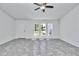 Bright living room with tile flooring, ceiling fan and natural light from the three front windows at 280 Marion Oaks Golf Way, Ocala, FL 34473