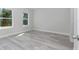 This bedroom has wood-look floors and two windows that let in natural light at 2844 Sw 162Nd Street Rd, Ocala, FL 34473