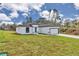 Exterior view of single-story home with a well-maintained front lawn and attached garage at 2844 Sw 162Nd Street Rd, Ocala, FL 34473