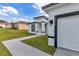 View of the home's exterior with an attached two-car garage and manicured lawn at 2844 Sw 162Nd Street Rd, Ocala, FL 34473